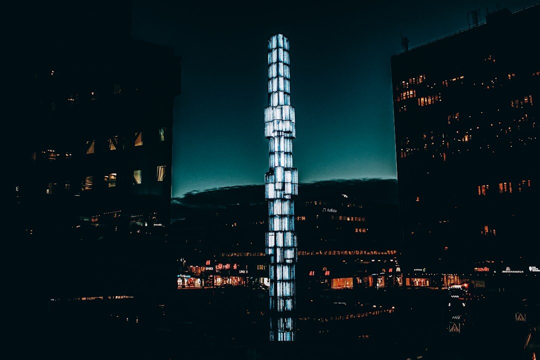 5G network tower with city lights at night